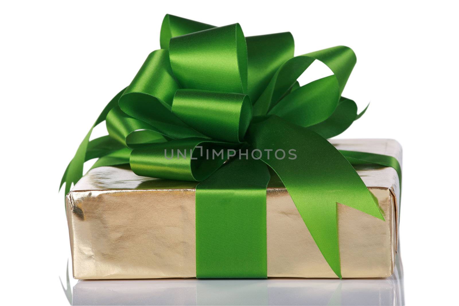 Gold present wrapped with green ribbons and bow