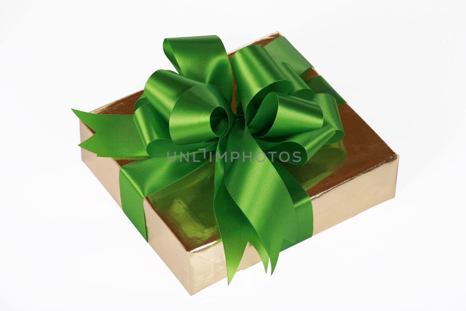 Gold present wrapped with green ribbons and bow