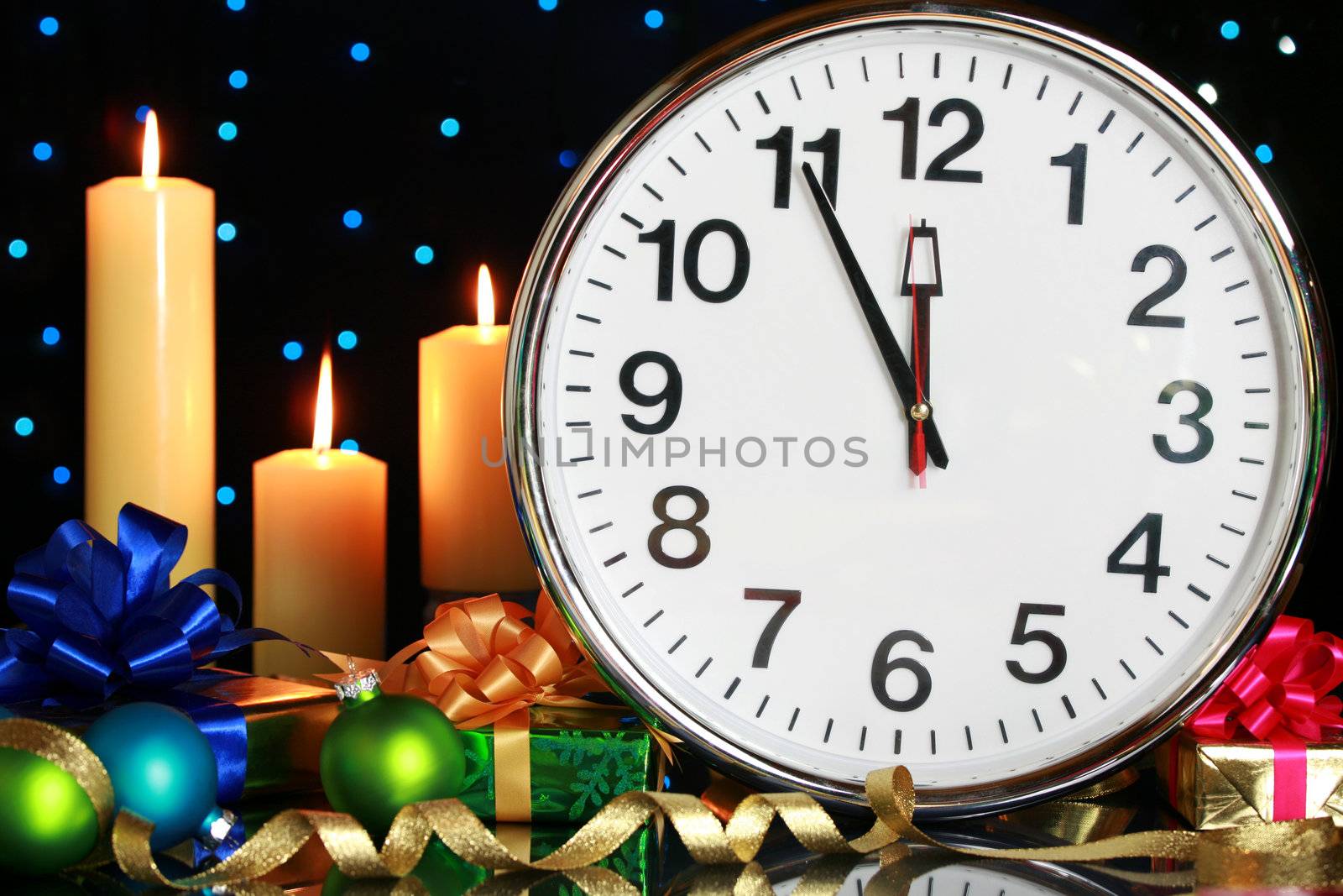 Five minutes to midnight, clock with Christmas candles and presents