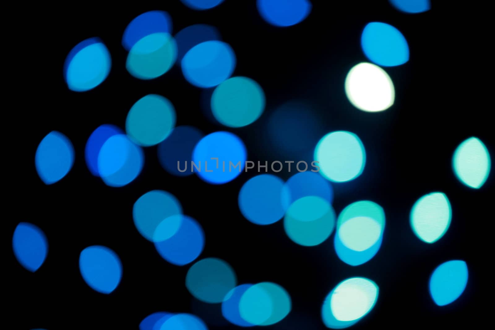 Defocused blue Christmas lights, as holiday background