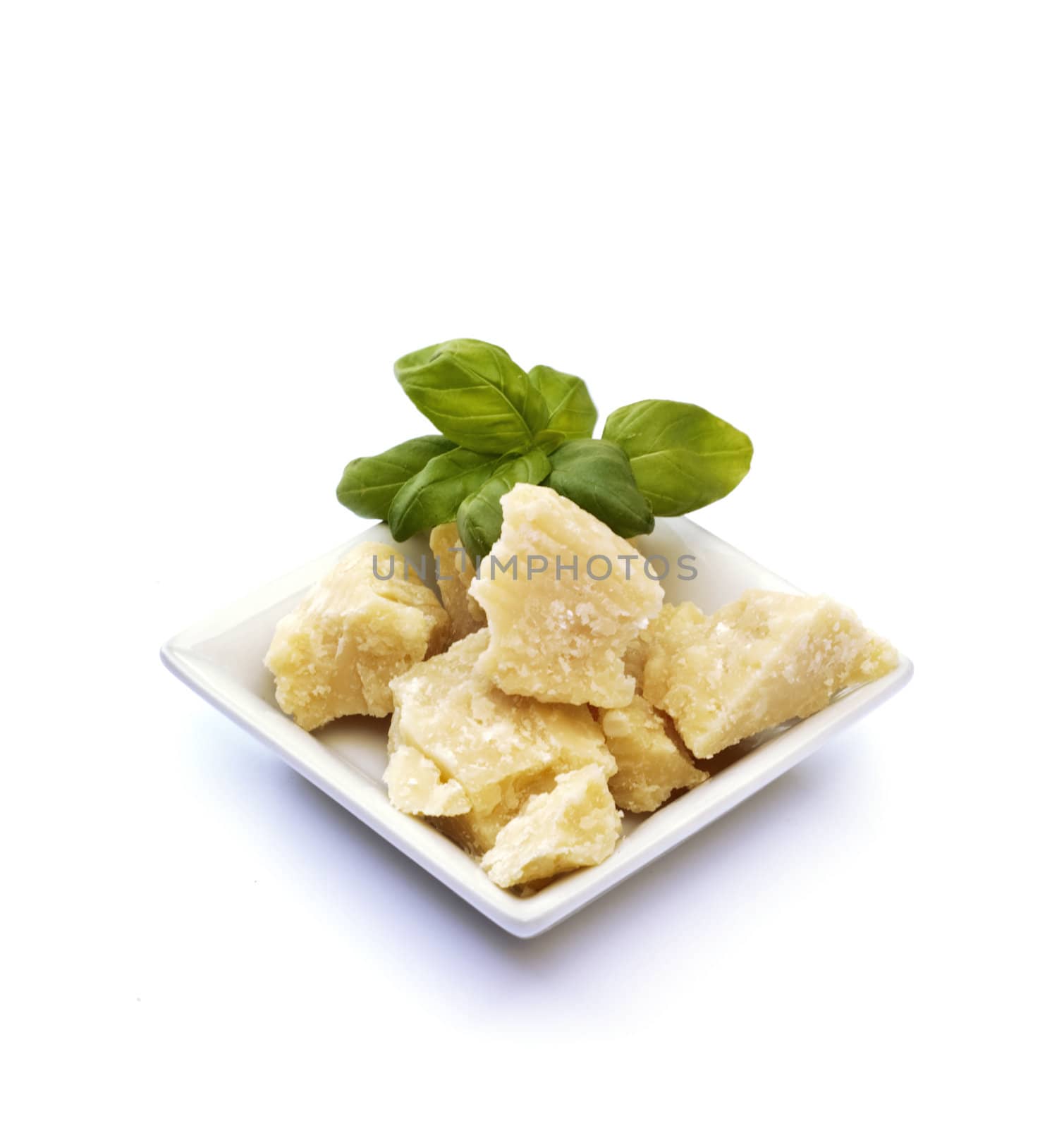 Small basket with  basil, and  parmesan on white background
