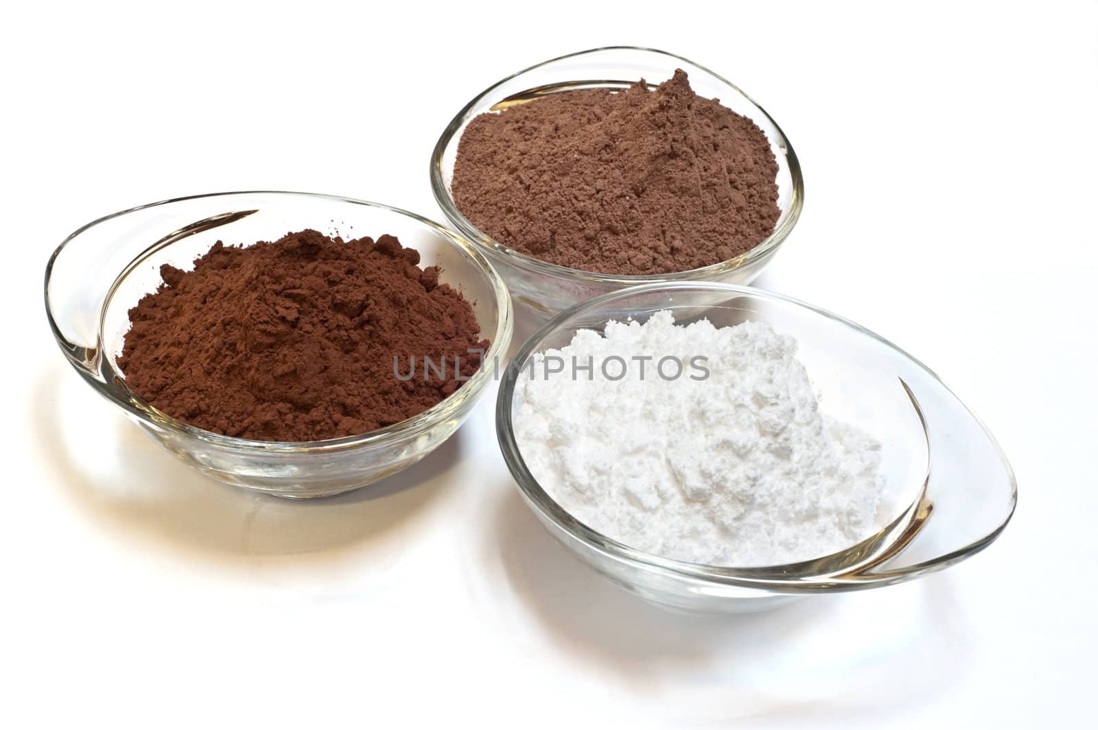 
cocoa cake and cocoa powder on a white background