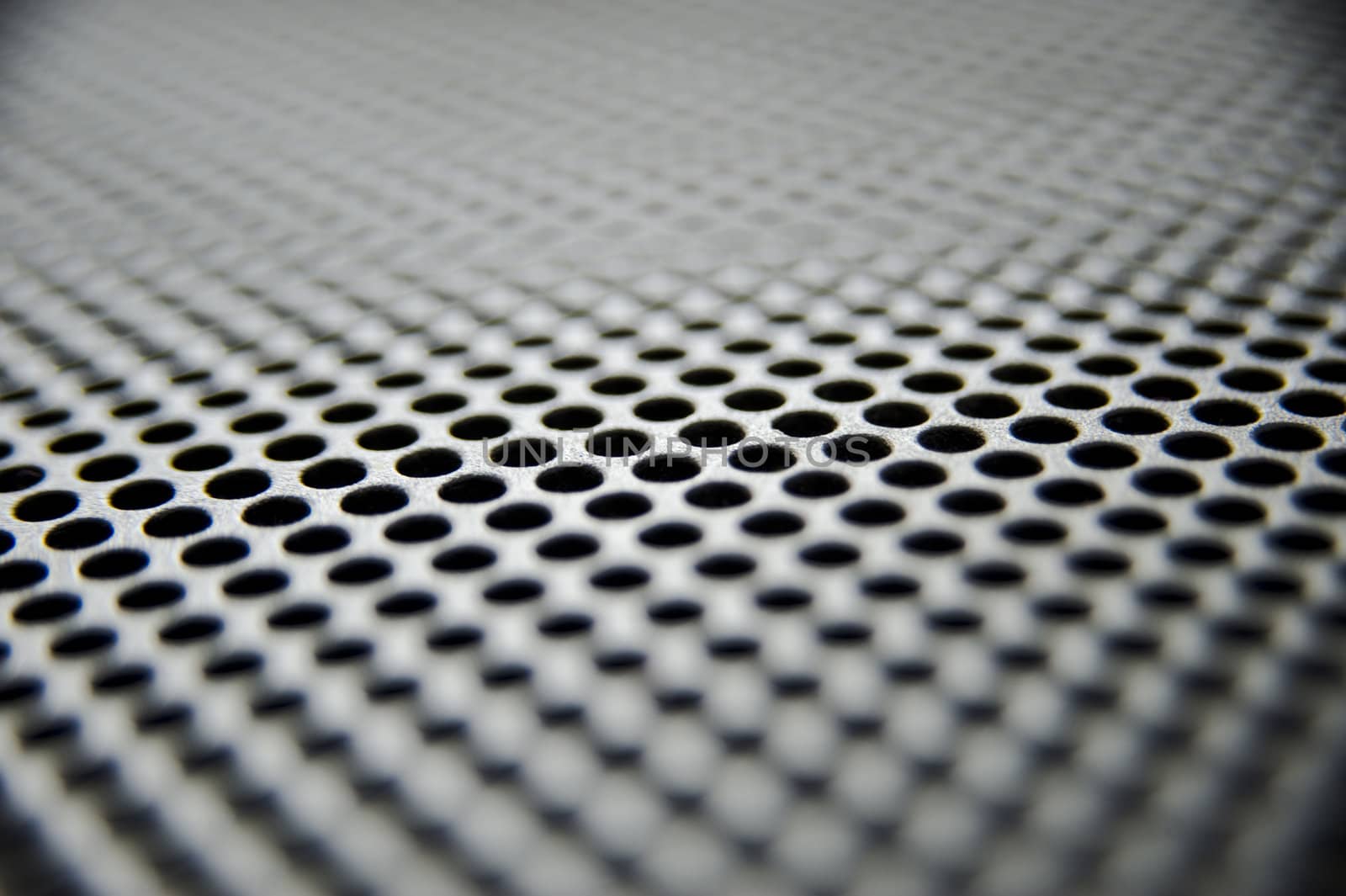Metal sheet with holes taken as closeup