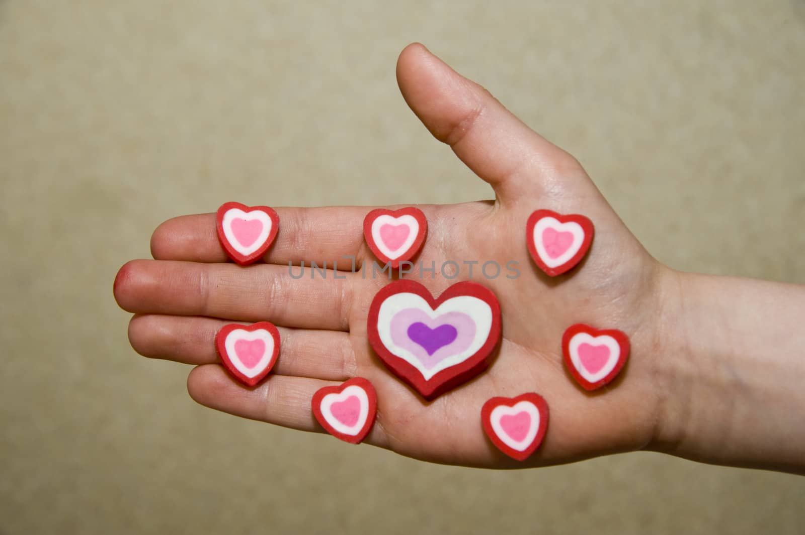 Beautiful symbolical hearts on a children's palm.