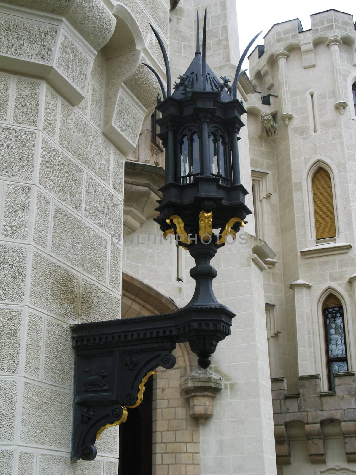 Old street lamp on the wall of ancient castle