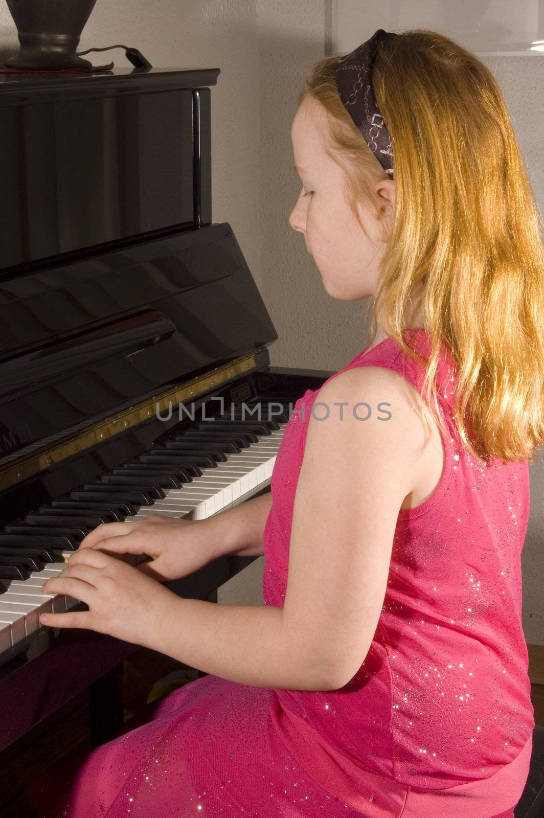 little girl is playing the piano by ladyminnie