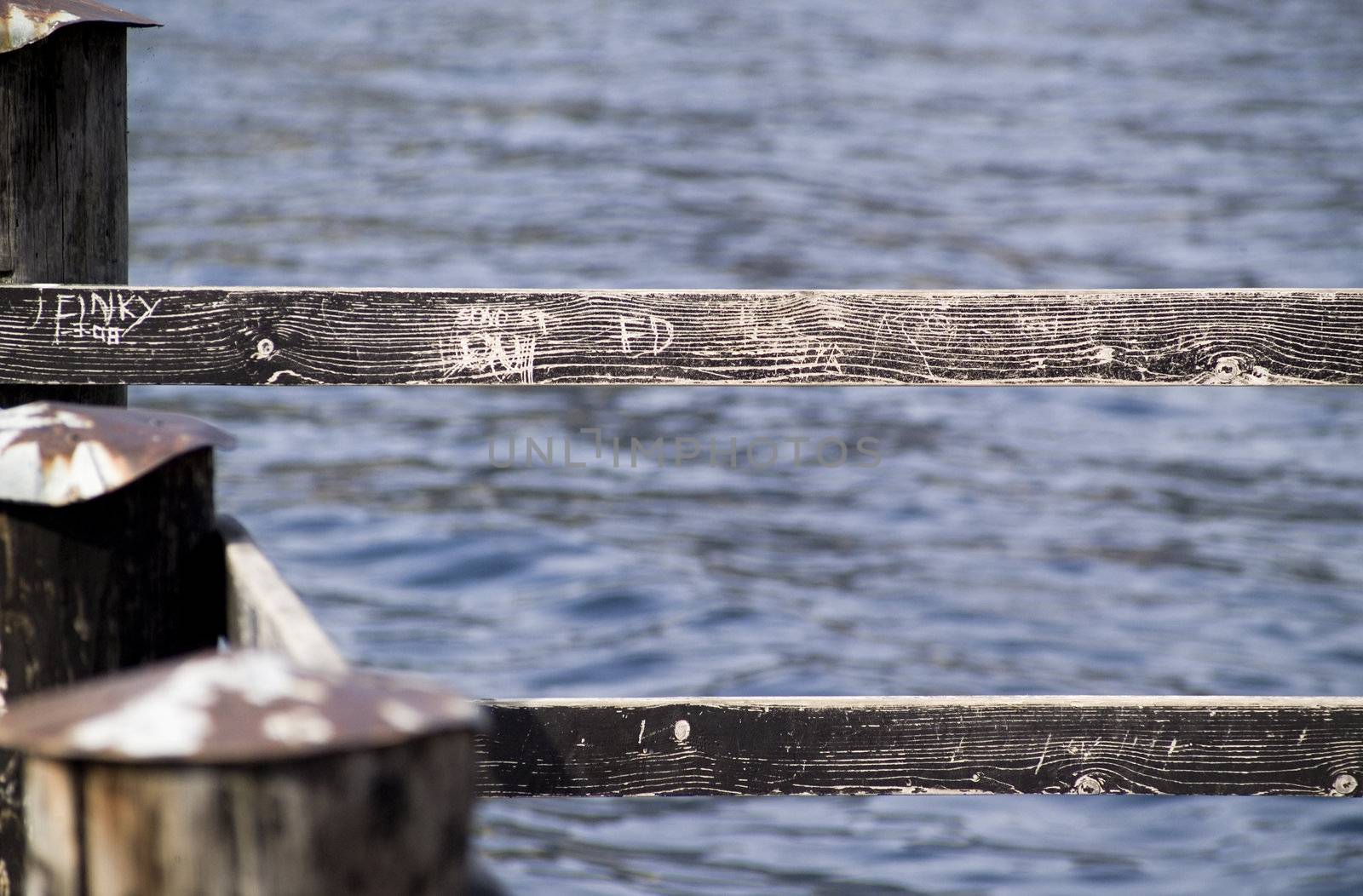 and old wood guard on a lake's dock 