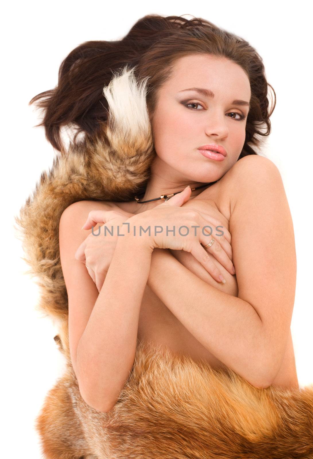 Nude woman lying covered with a fox fur