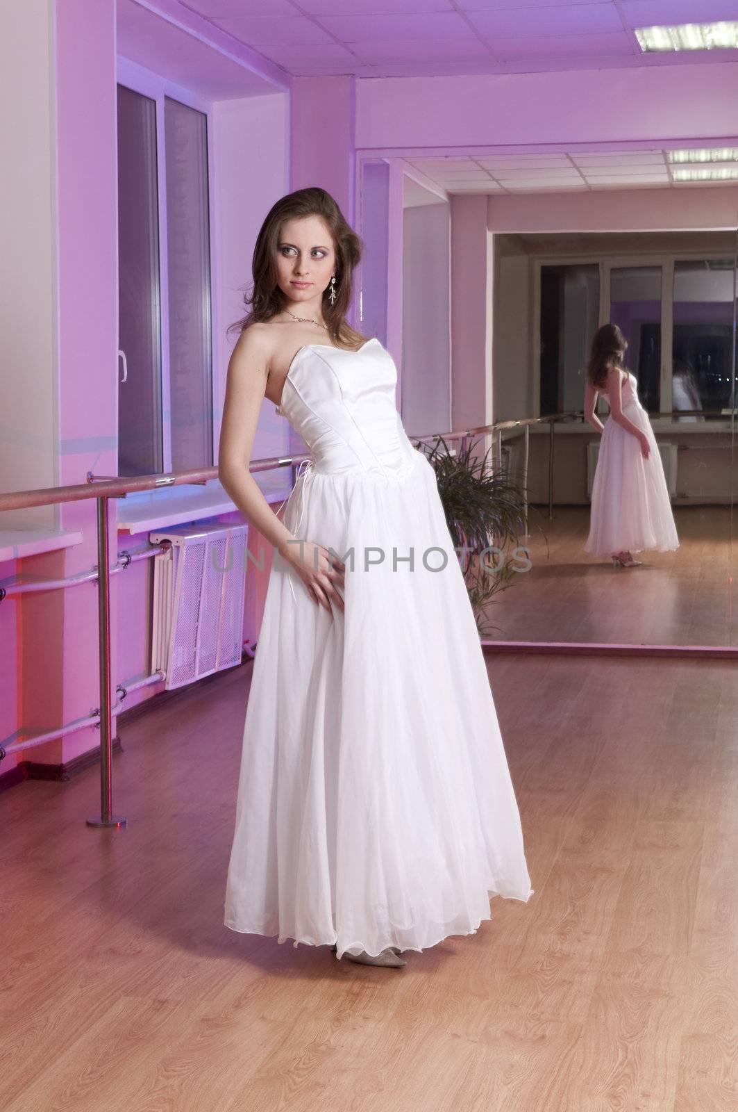 Girl in white wedding dress in dance studio