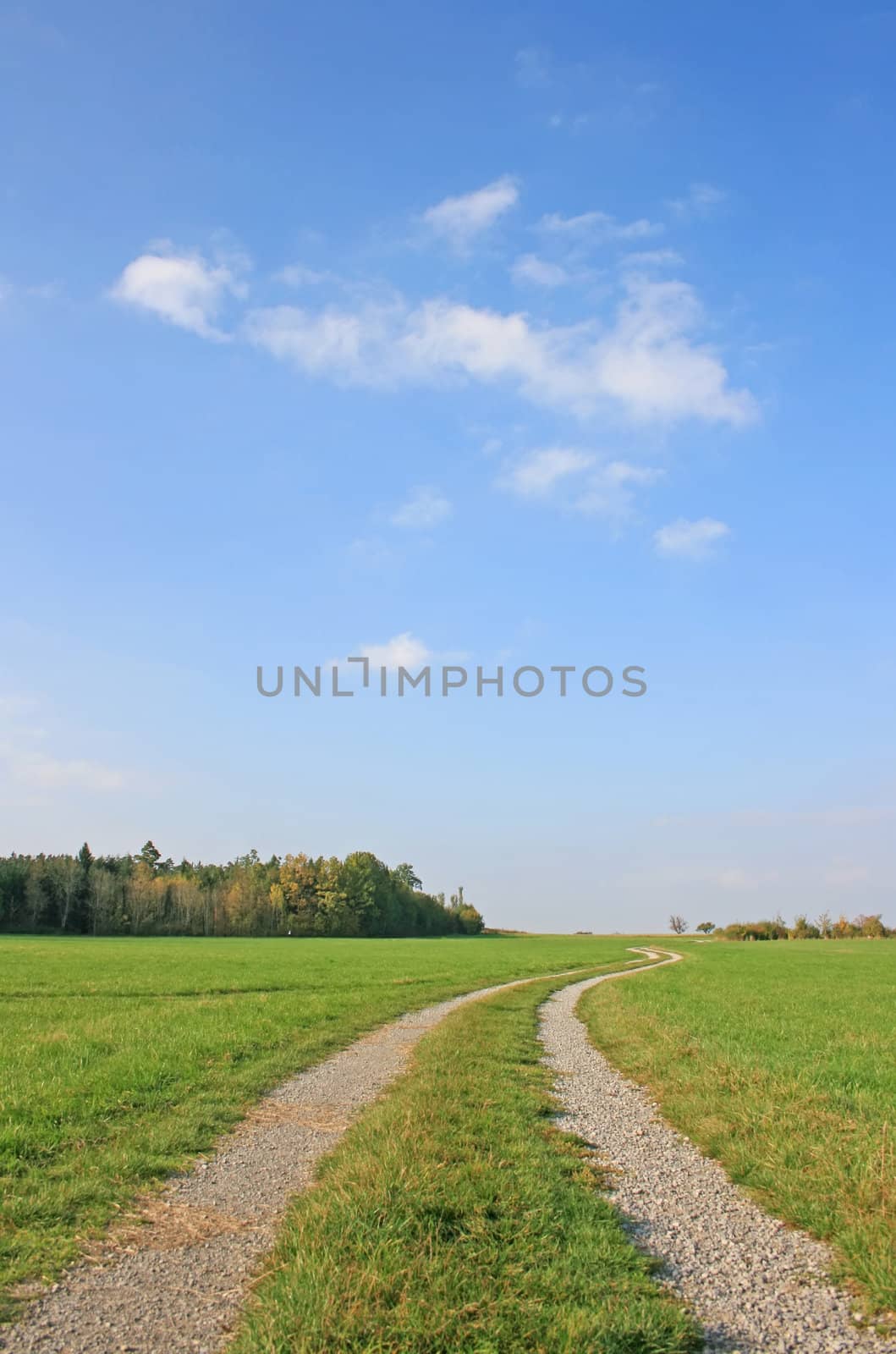 This image shows a country road with sky and clouds