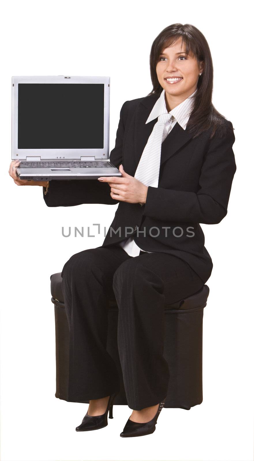 Smiling businesswoman presenting something to her notebook.Empty laptop screen to put there your content. 