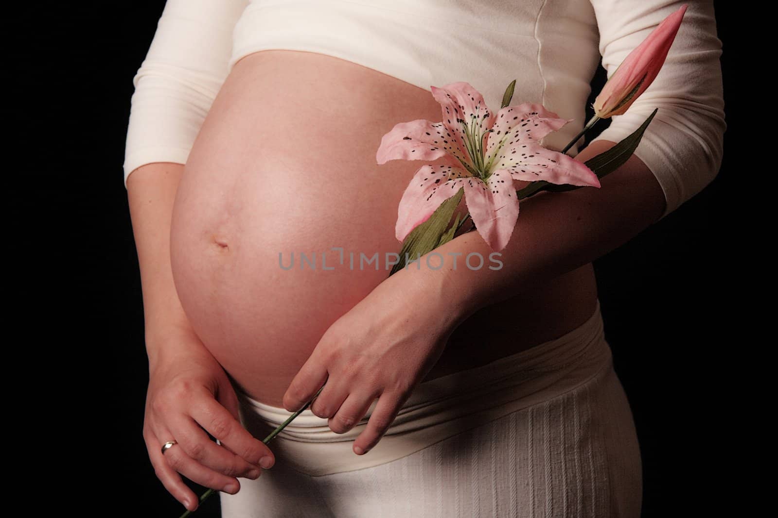 Pregnant mother holding belly exposing the bump