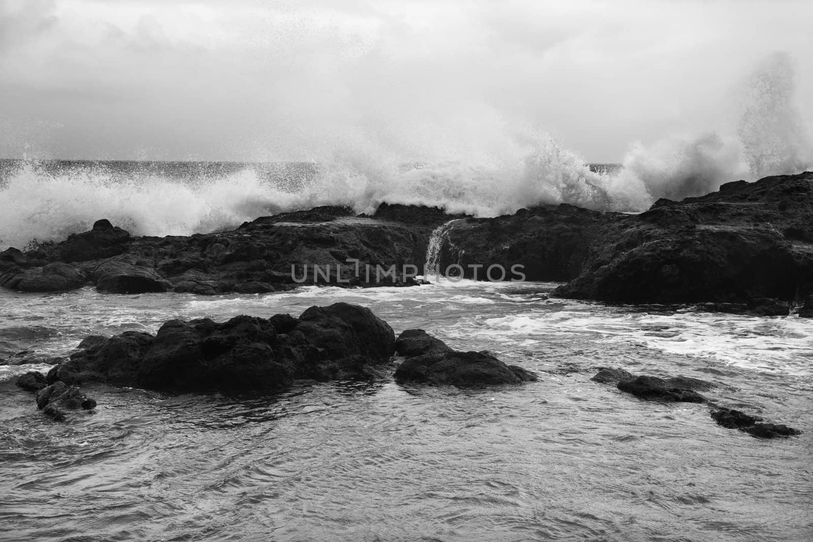 Waves on rocks. by iofoto