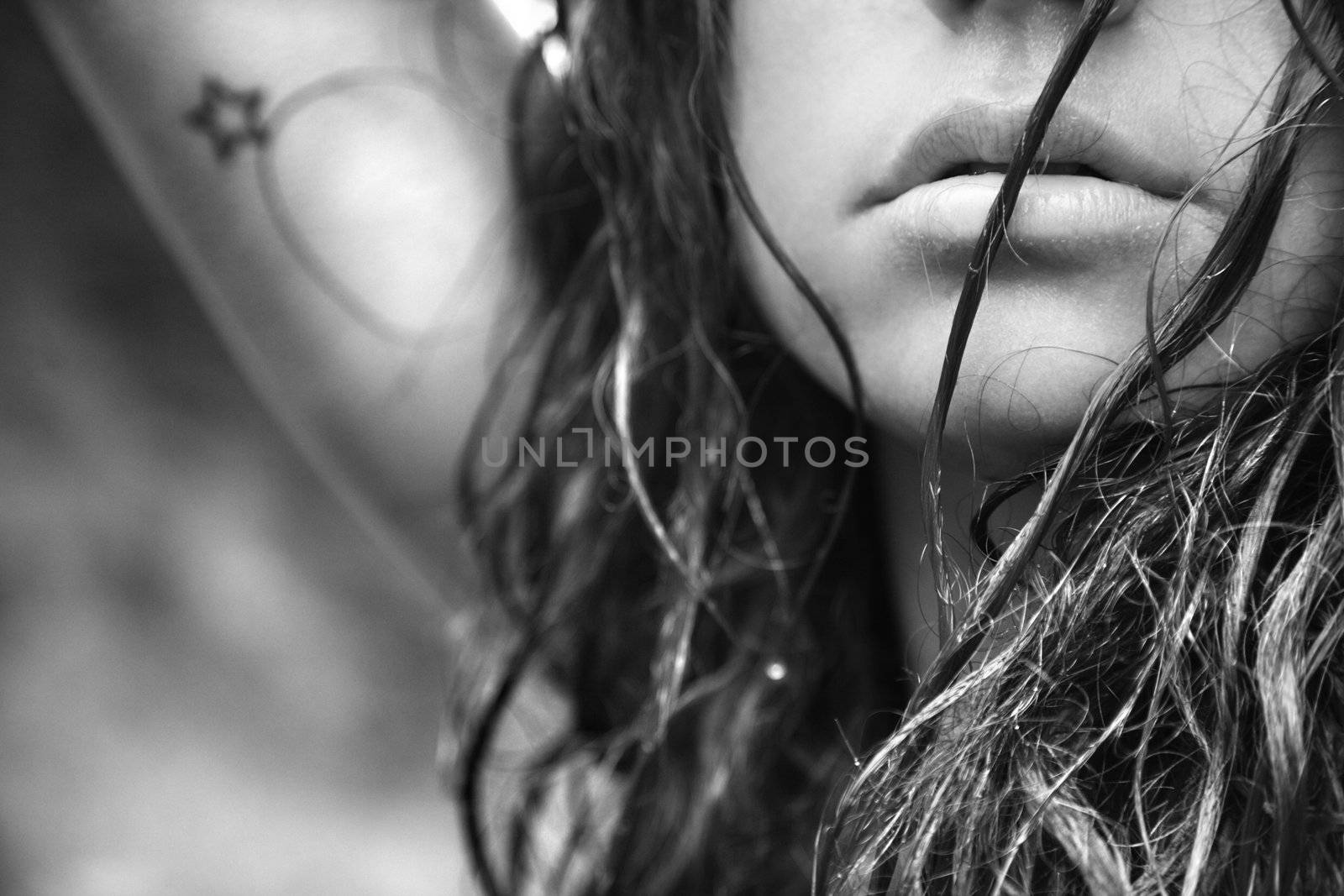 Young adult Caucasian female face and disheveled hair.