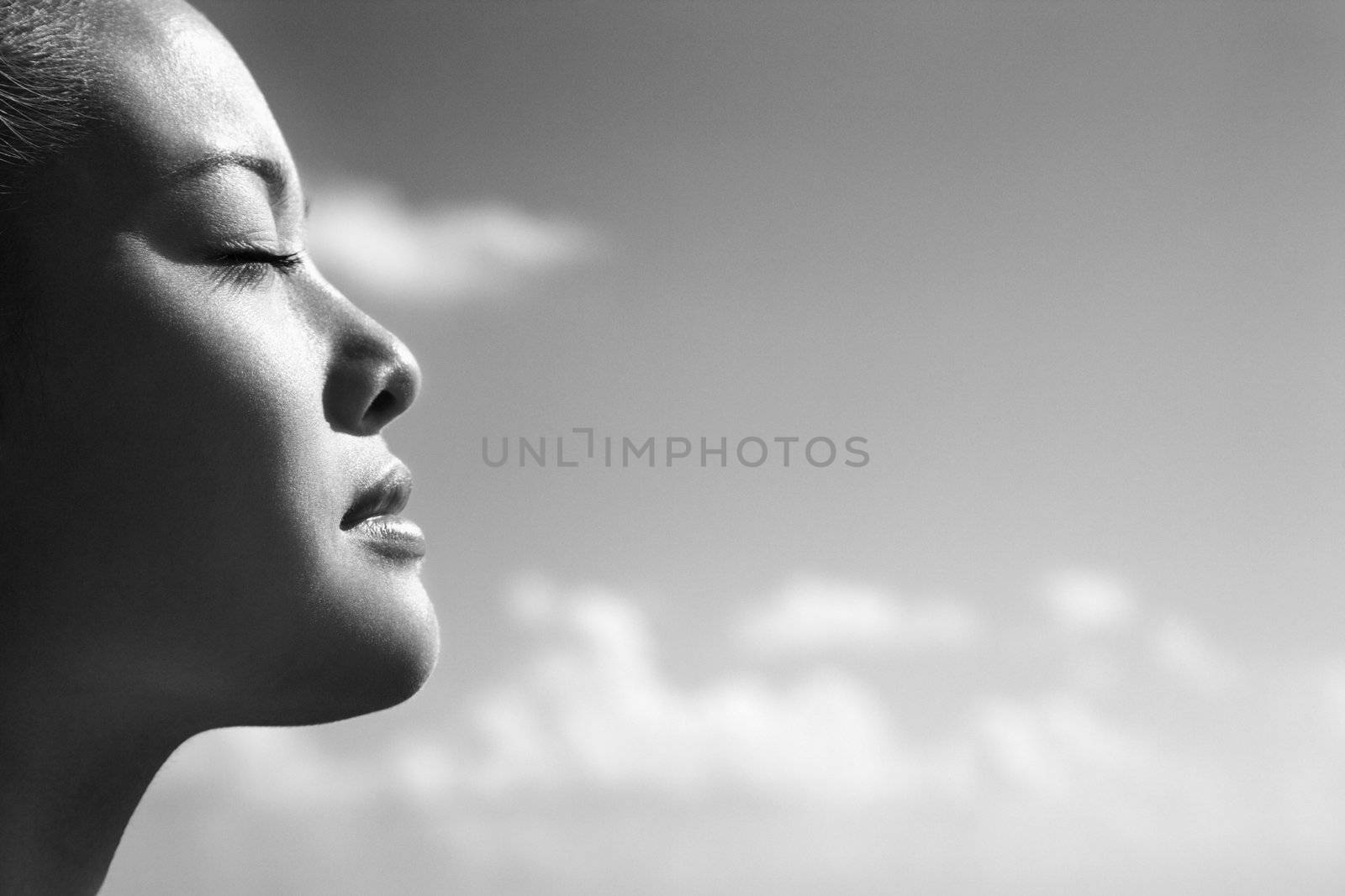 Woman with eyes closed. by iofoto