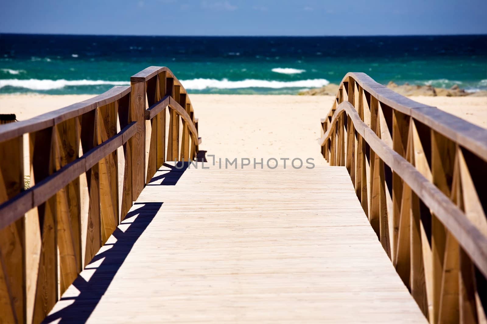 Wooden stairs on deserted beach dunes in Tarifa, Spain