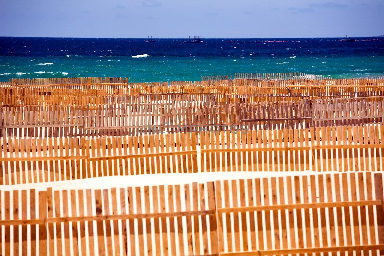 Wooden fence on deserted beach dunes in Tarifa, Spain