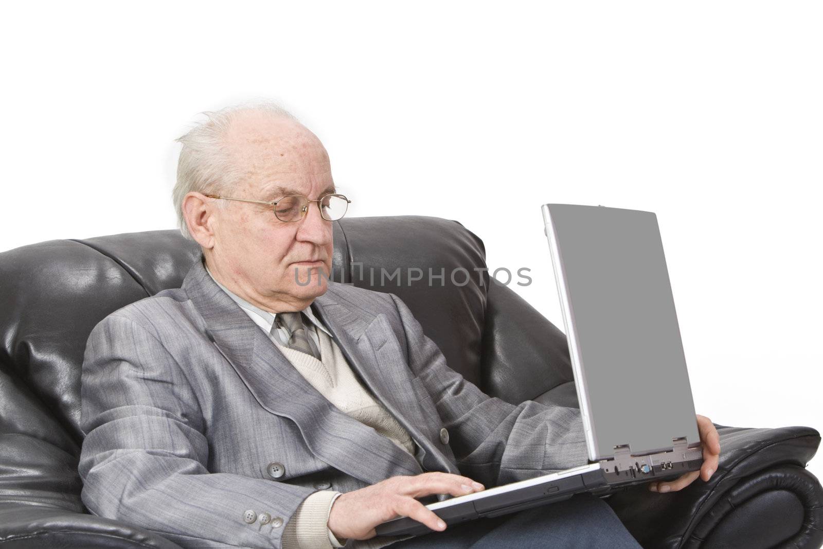 Close-up image of a senior man using a laptop.