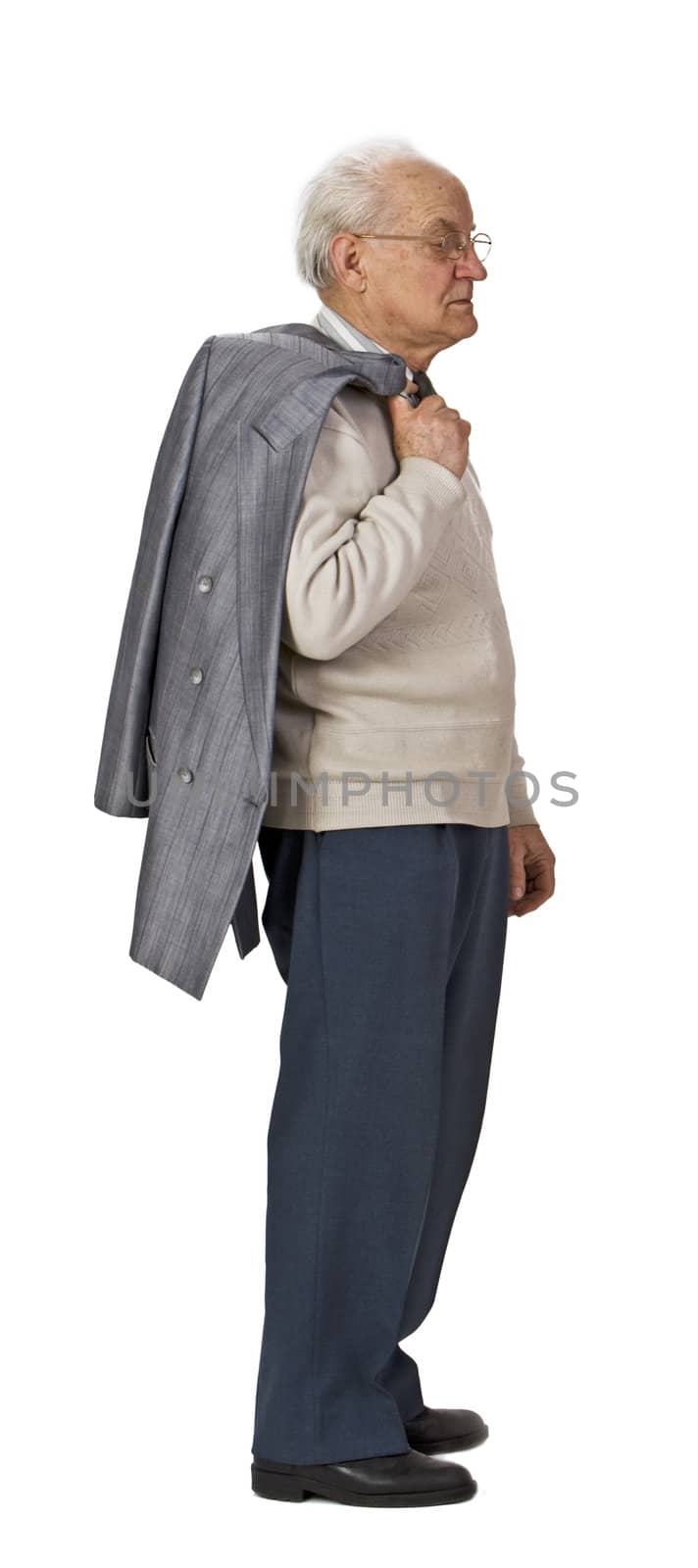 Senior man with a coat over his shoulder standing-up against a white background,profile.