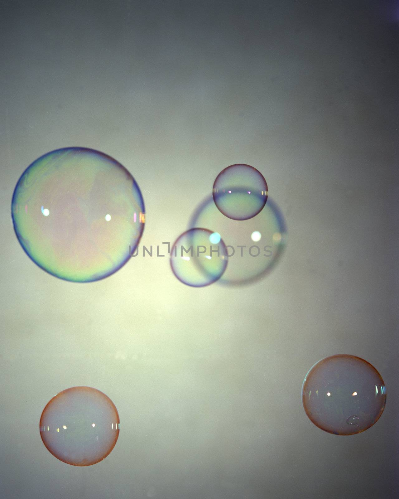 Floating colored bubbles on a grey background
