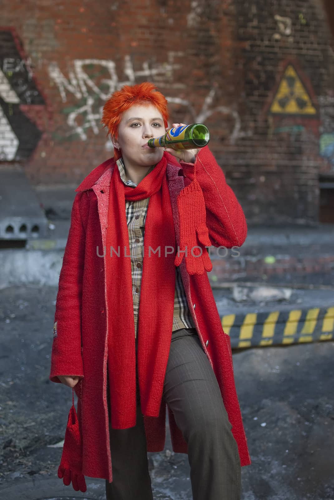 Red-haired woman is drinking beer
