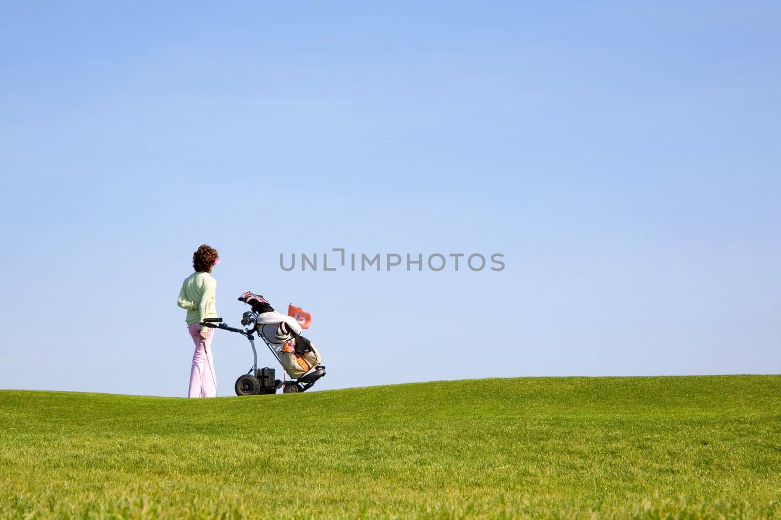 Golfer and caddy on the green