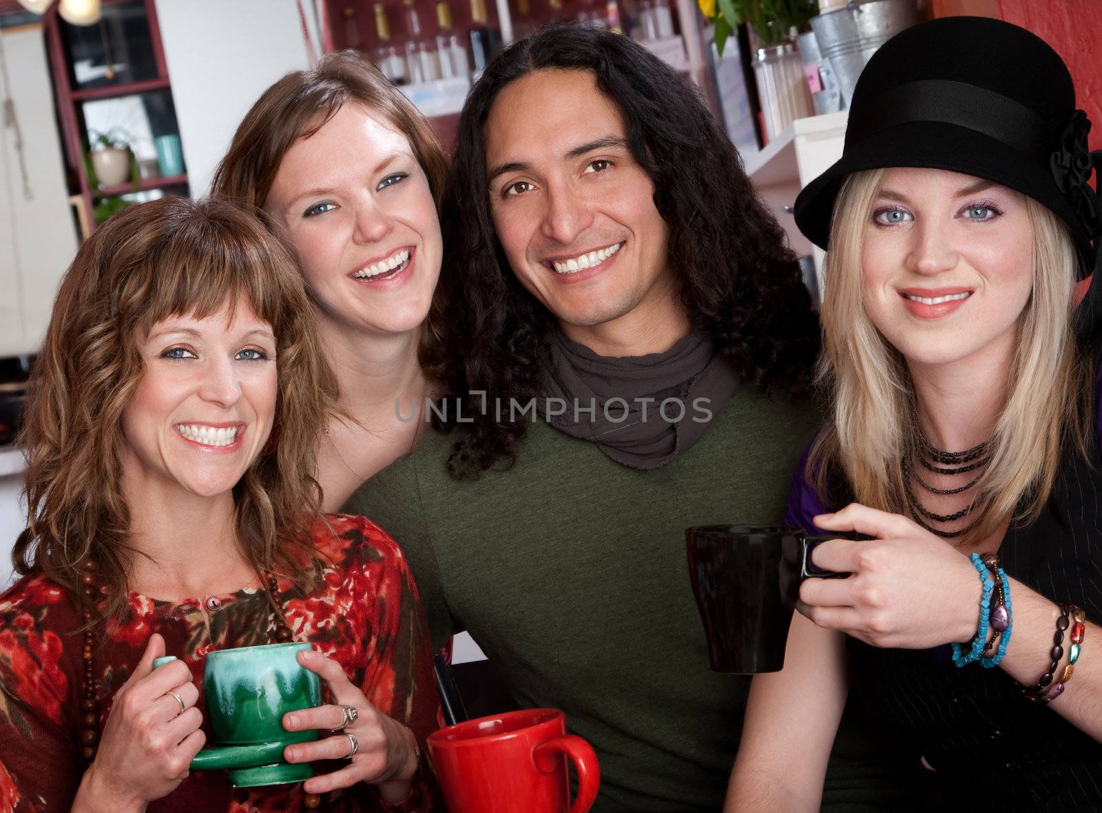 Four young friends drinking coffee at a cafe