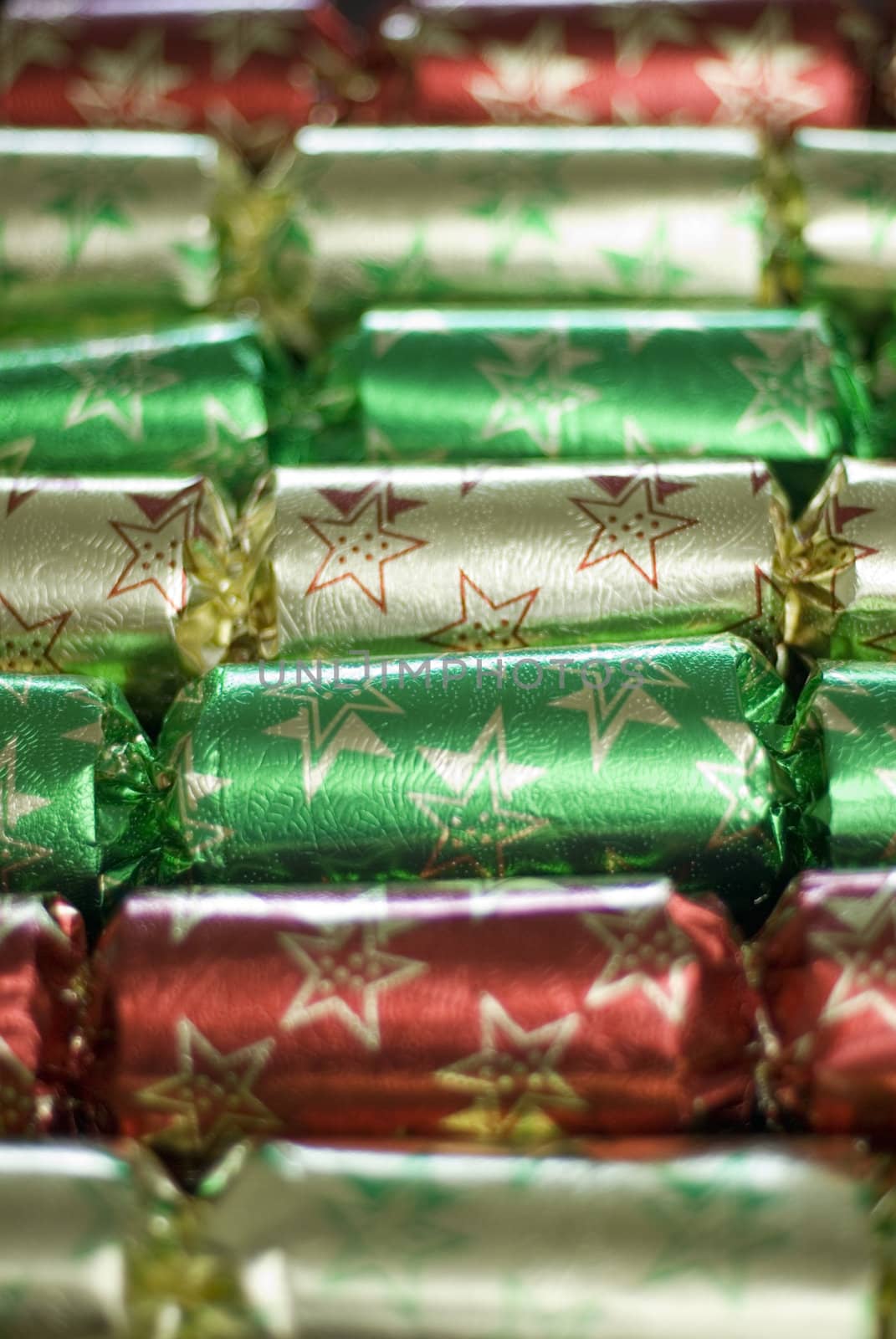 a line of metallic christmas crackers pictured with a narrow depth of field
