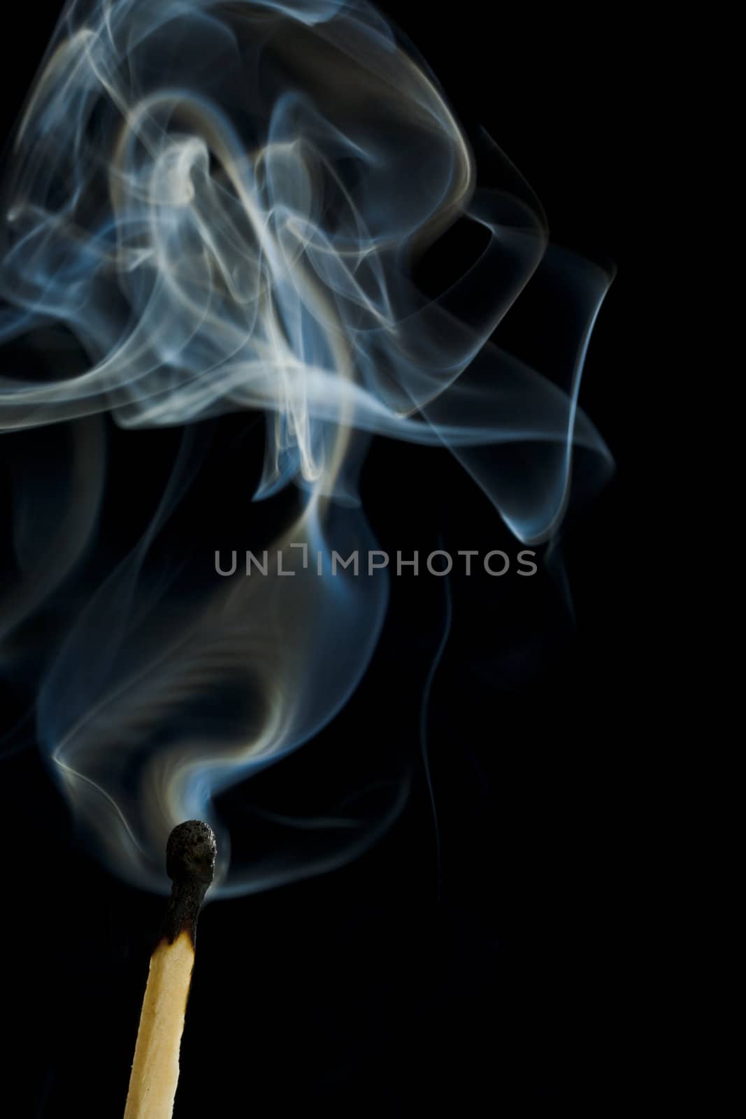 burnt matchstick with white and blue smoke