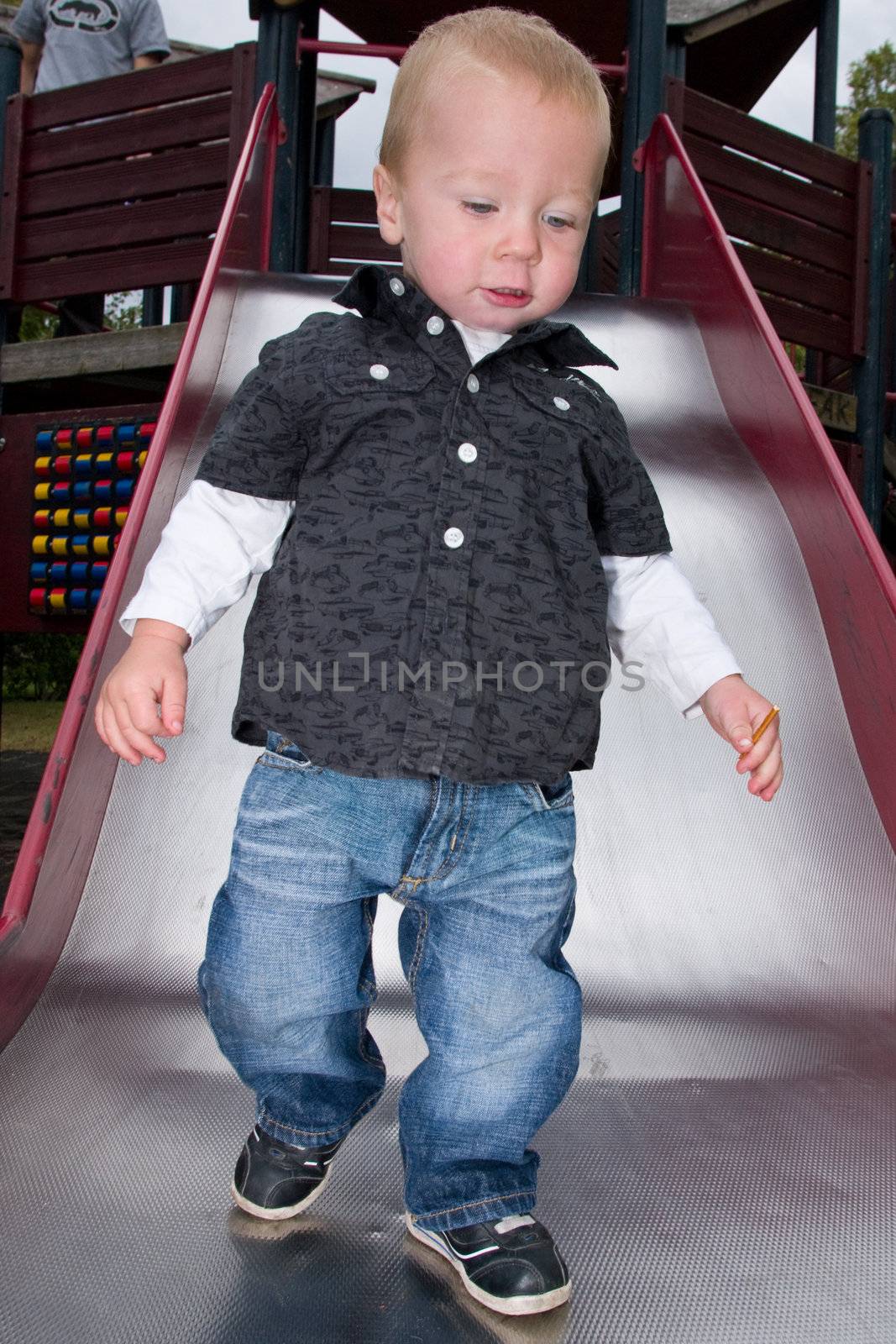 a little boy walking on a shute