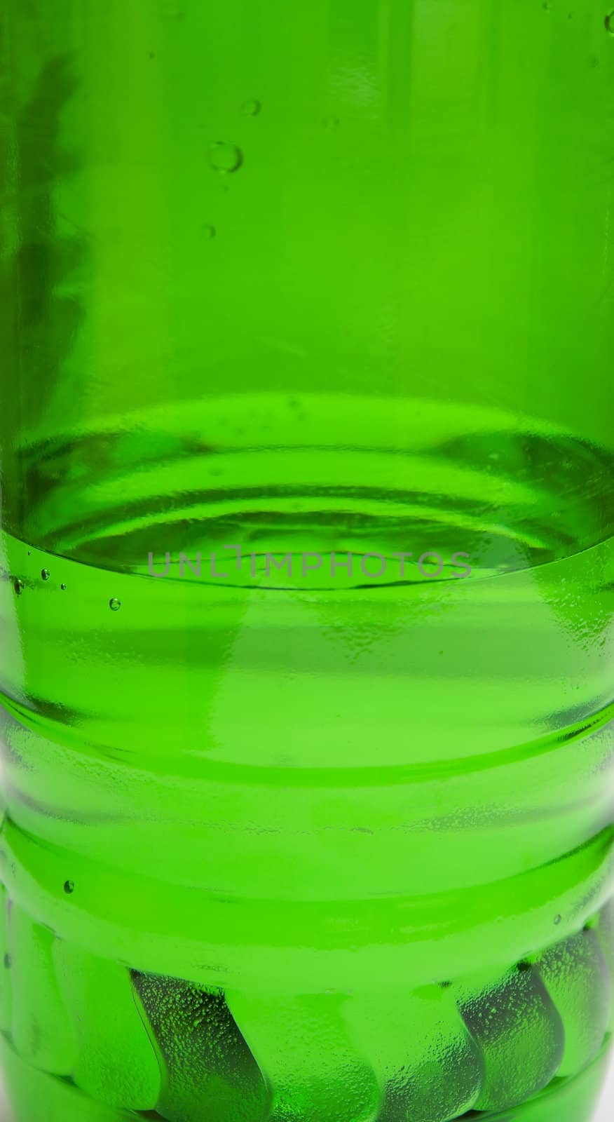 Green plastic bottle with water. A background, macro