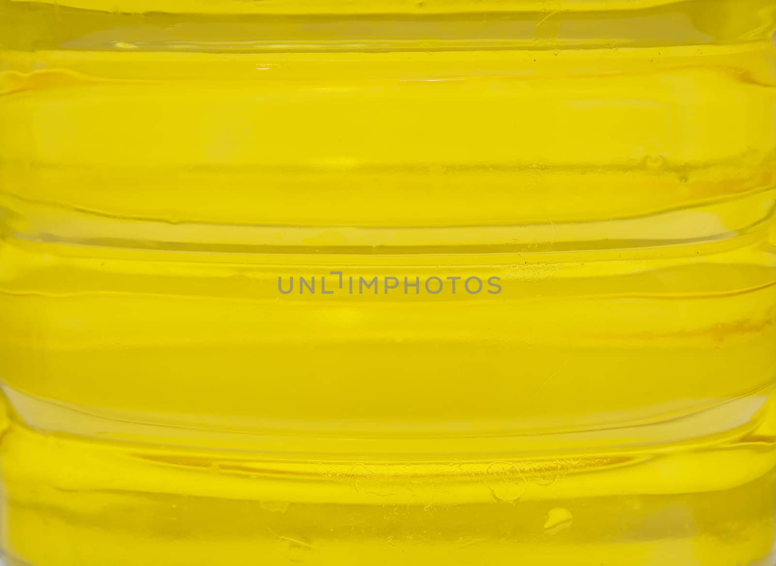 plastic bottle with yellow oil. A background, macro