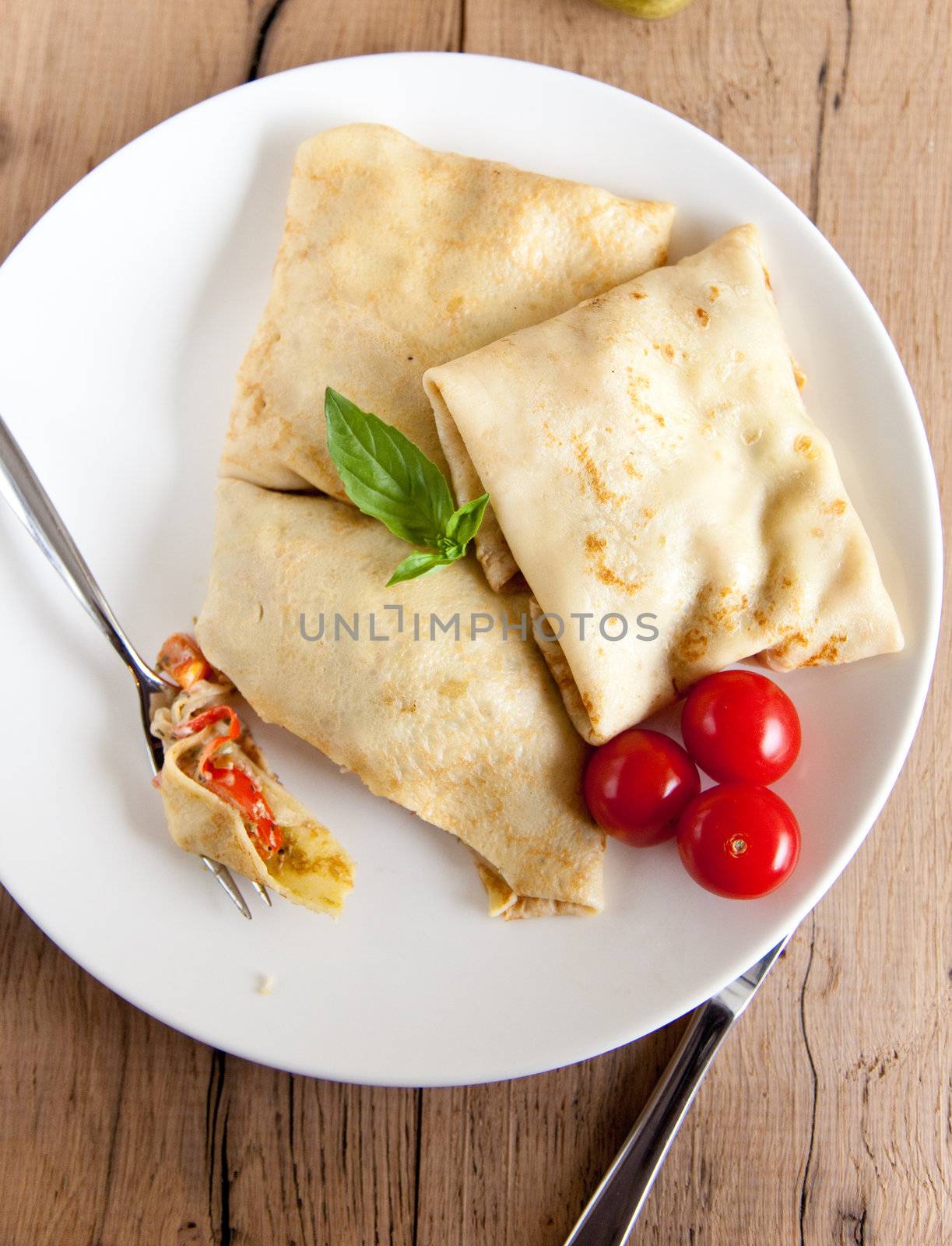 Savoury filled pancakes with basil and tomatoes