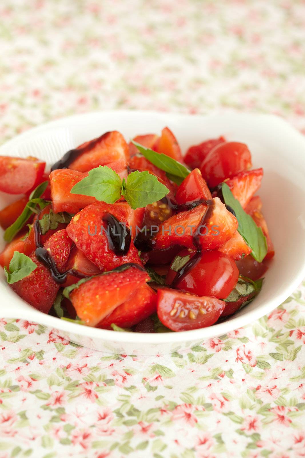 Delicious healthy salad with strawberries and tomatoes