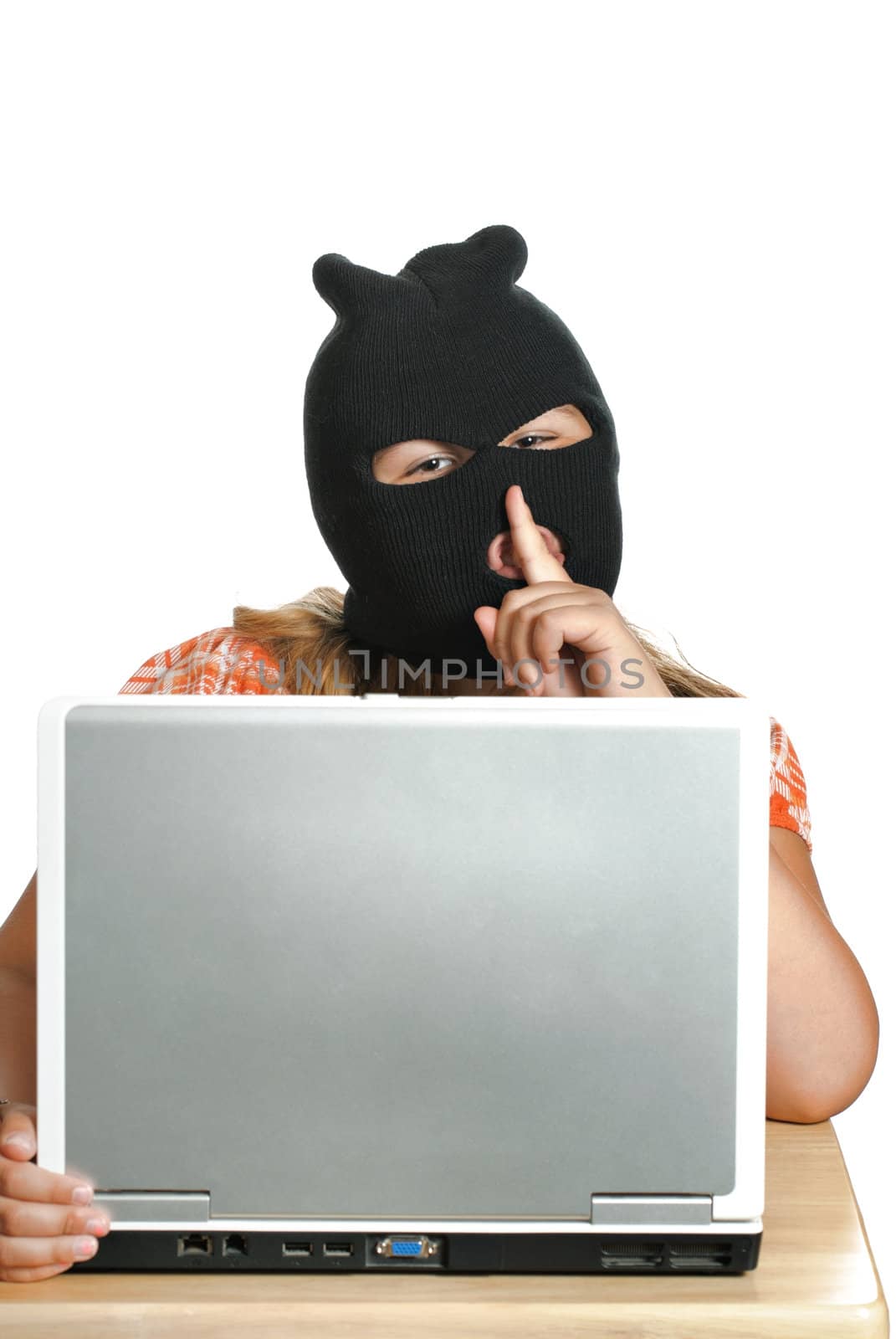 A young child hacker is working on a computer saying shhh, isolated against a white background.