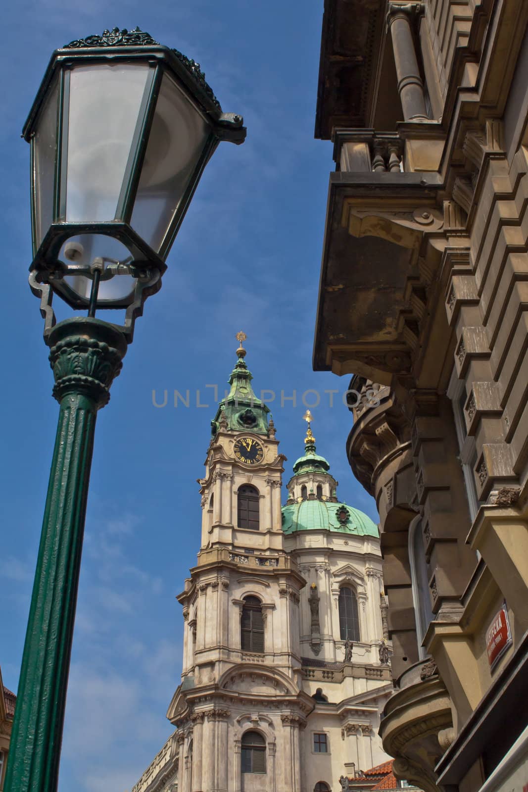 The old street lamp at the Prague street overlooking the clock tower