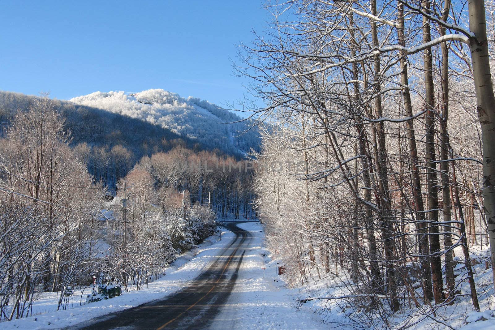 Mountain road in winter on a sunny morning