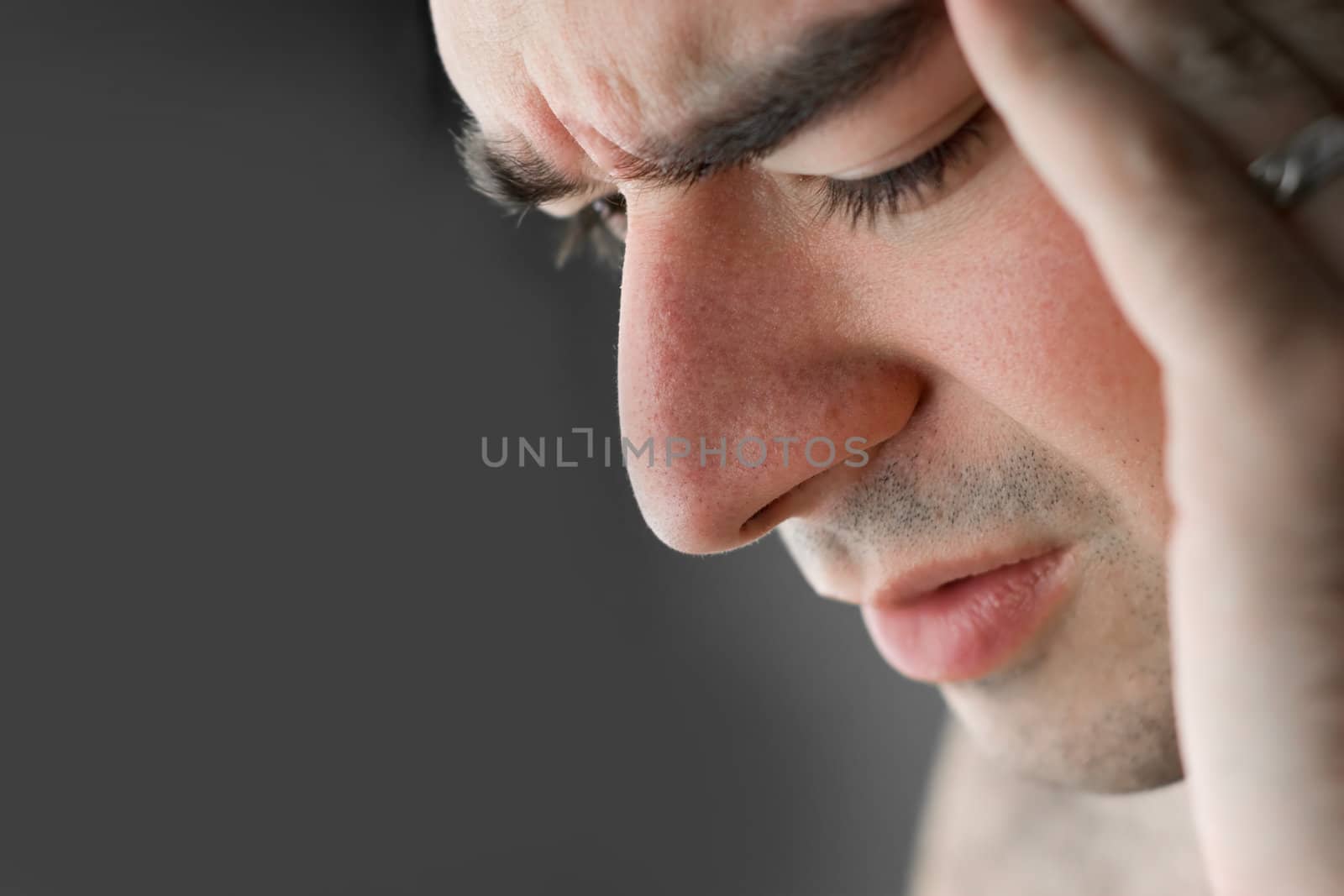 A young man that has an intense headache.