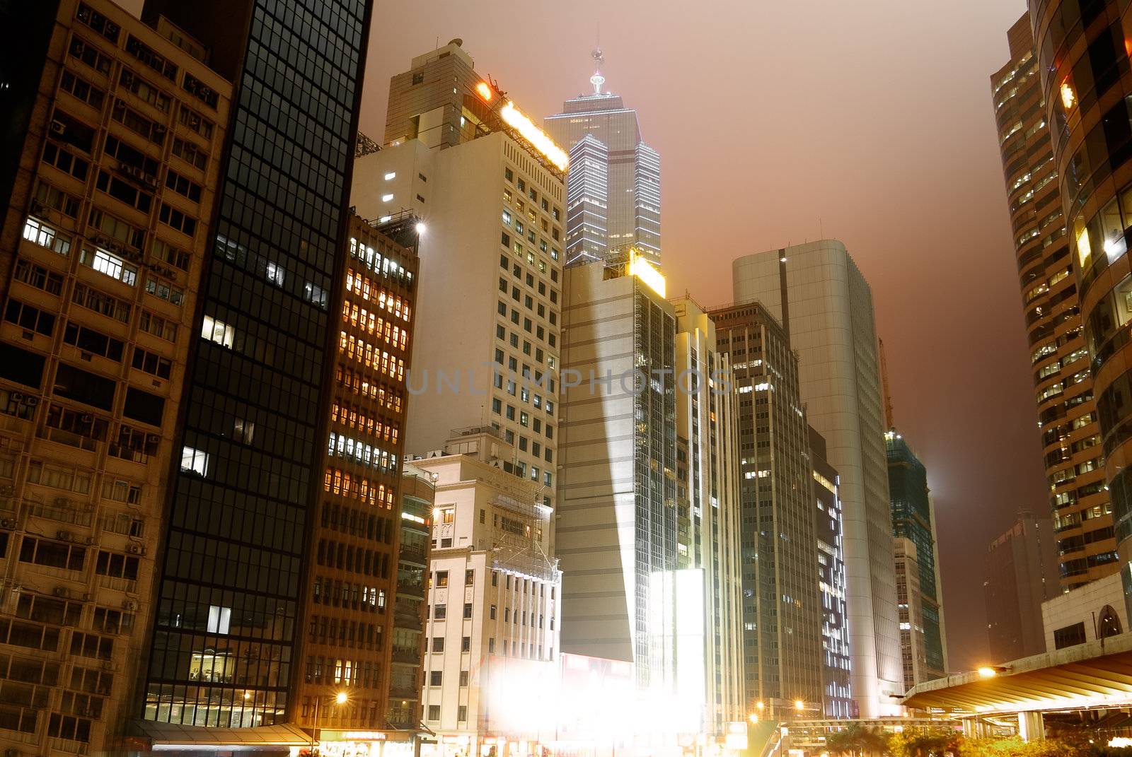 City night with skyscraper and office building in Hong Kong.