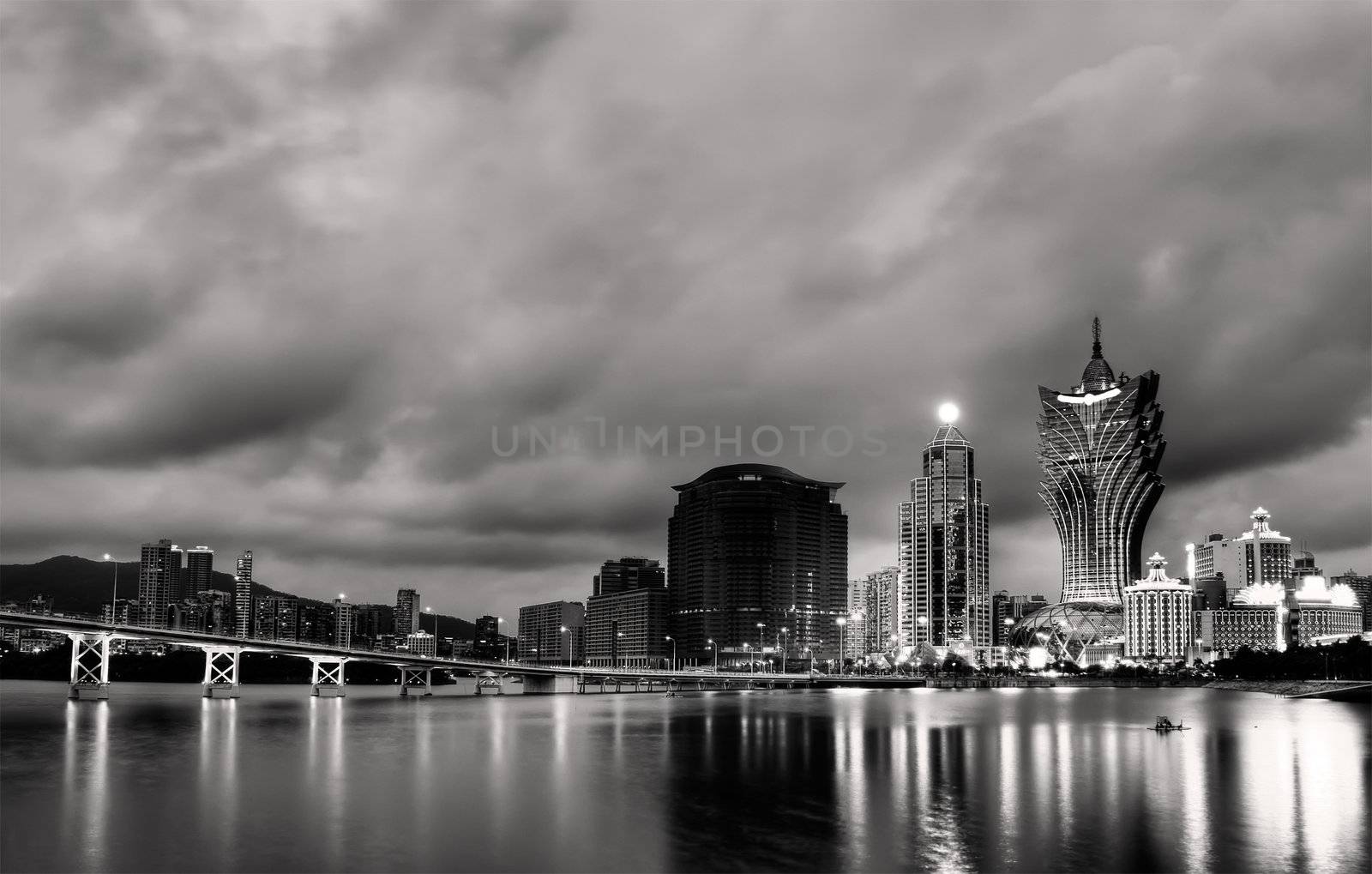Cityscape in Macao with skyscraper and bridge in night.