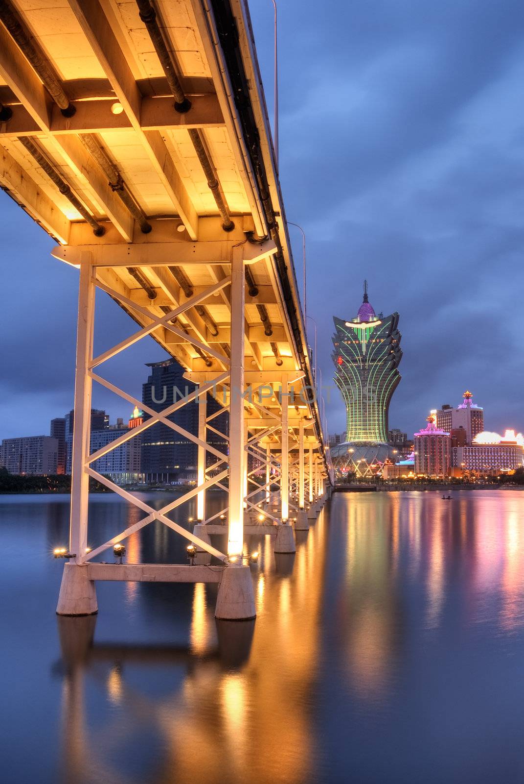 Bridge and skyscraper in night, famous landmark in Macao, China.