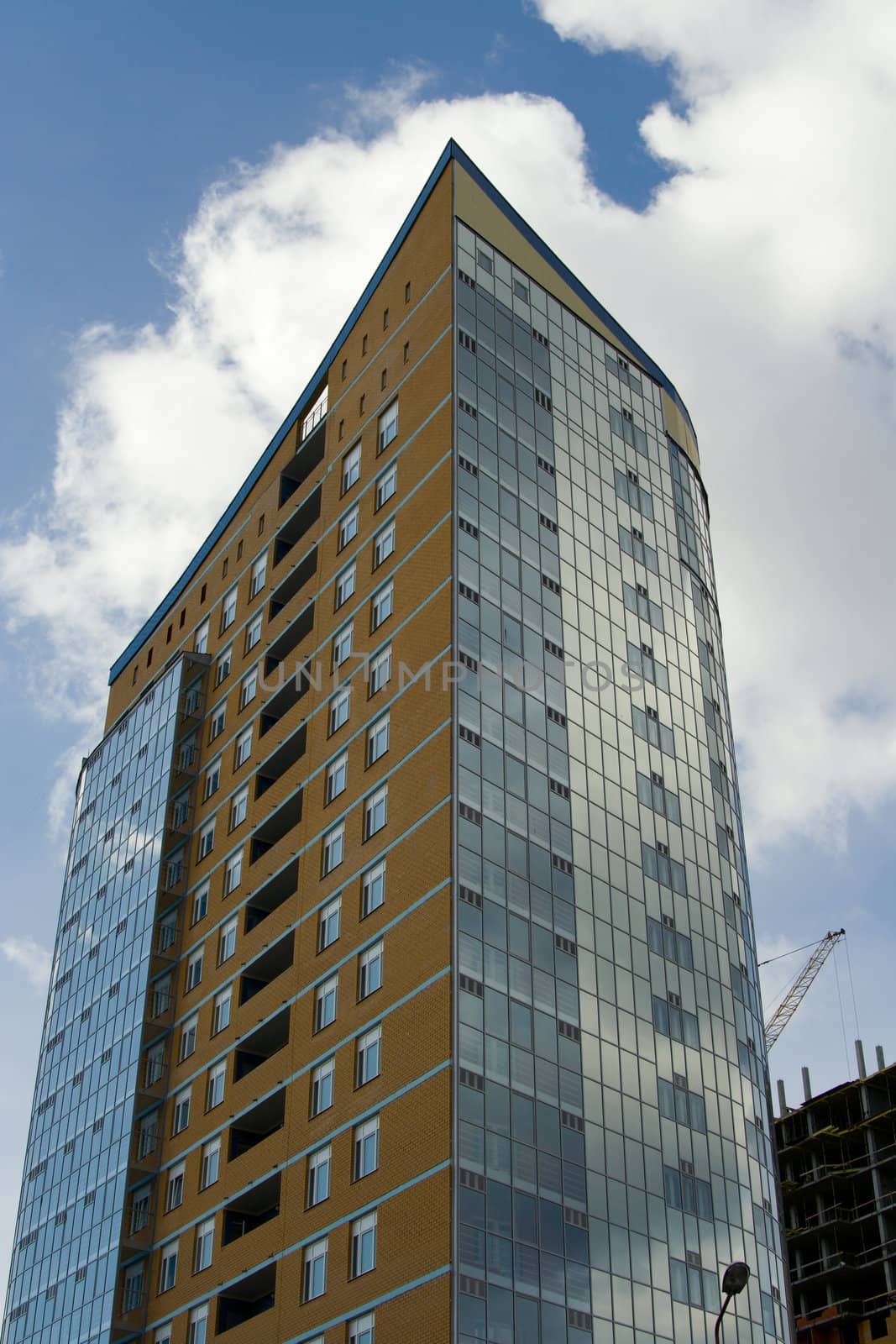 A under construction skyscraper on a background of the sky