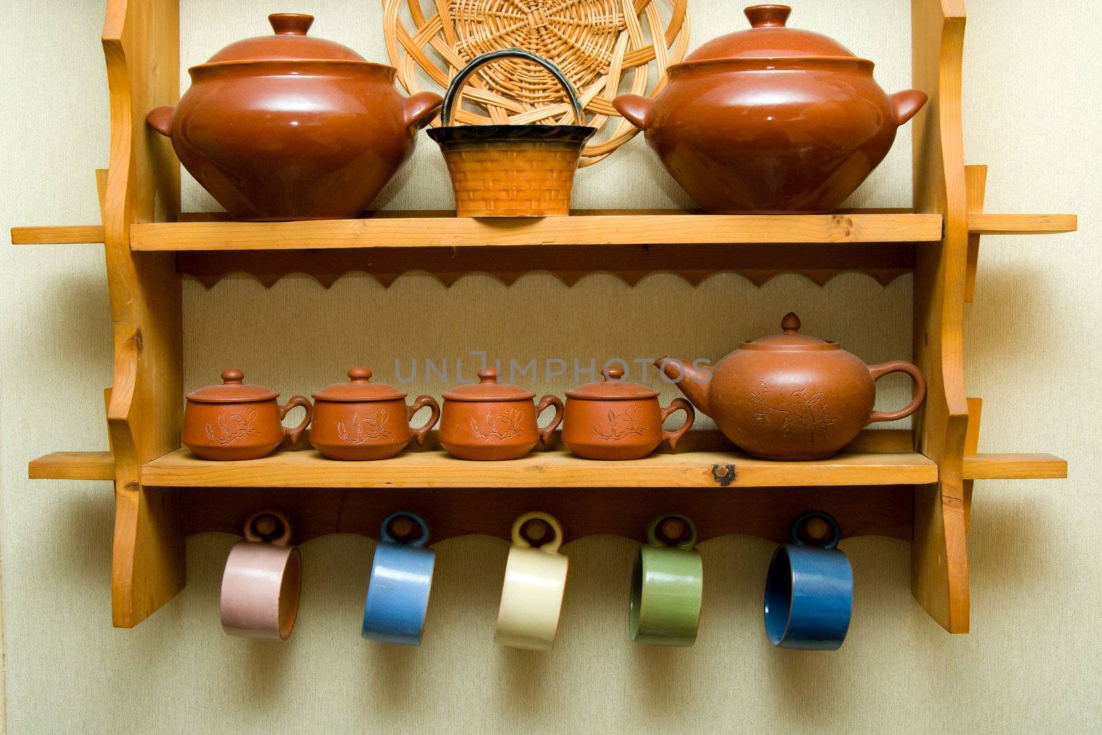 Ceramic utensils on a wooden shelf