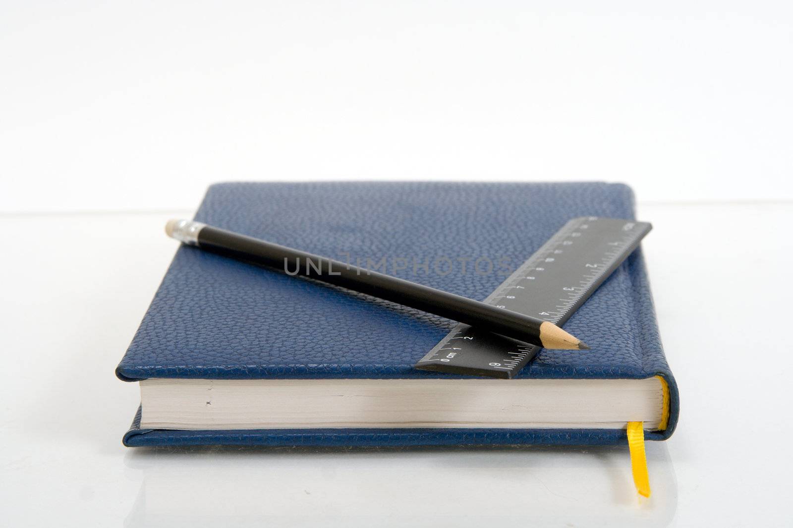 Dark blue notebook on a table. Close up.