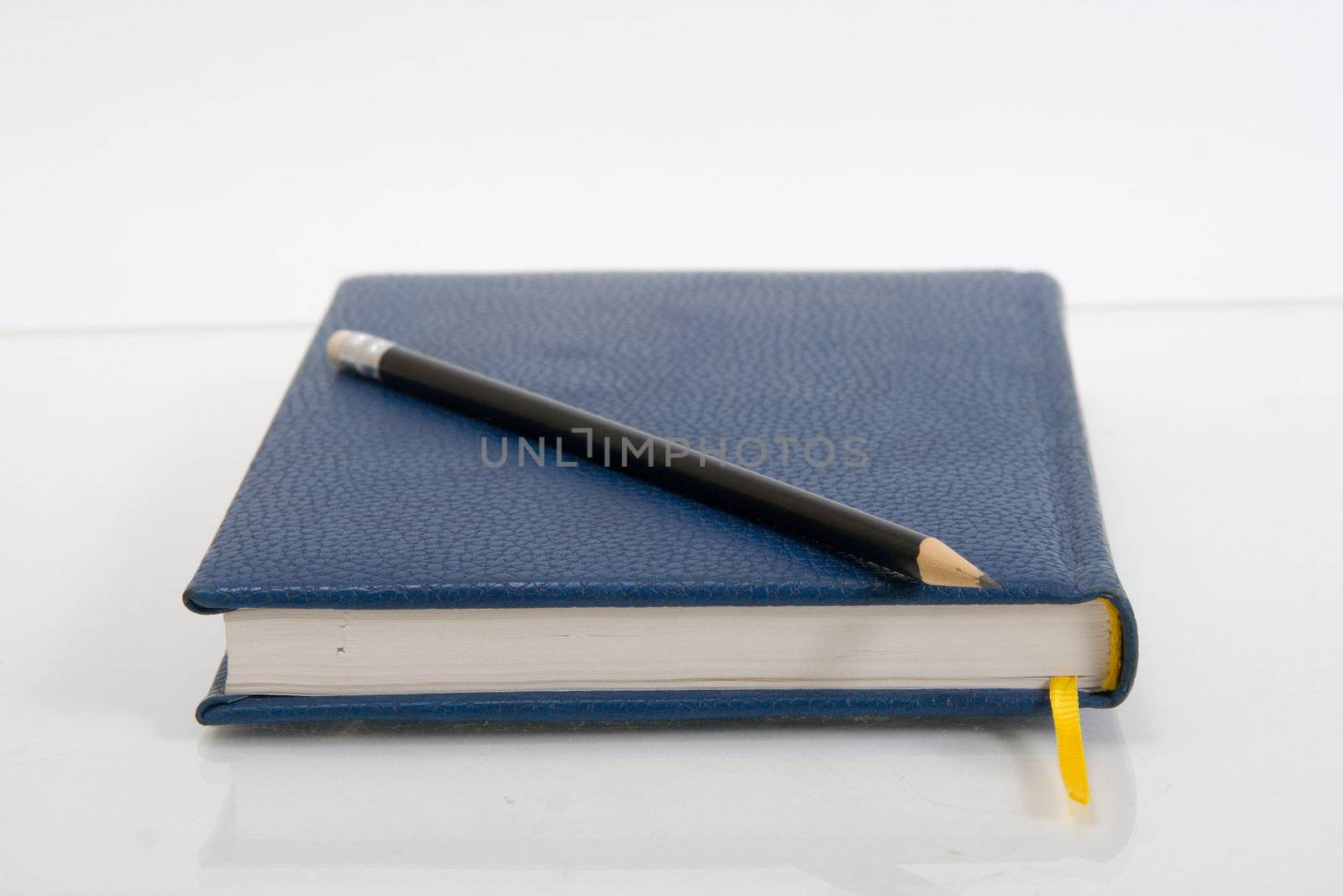 Dark blue notebook on a table. Close up.