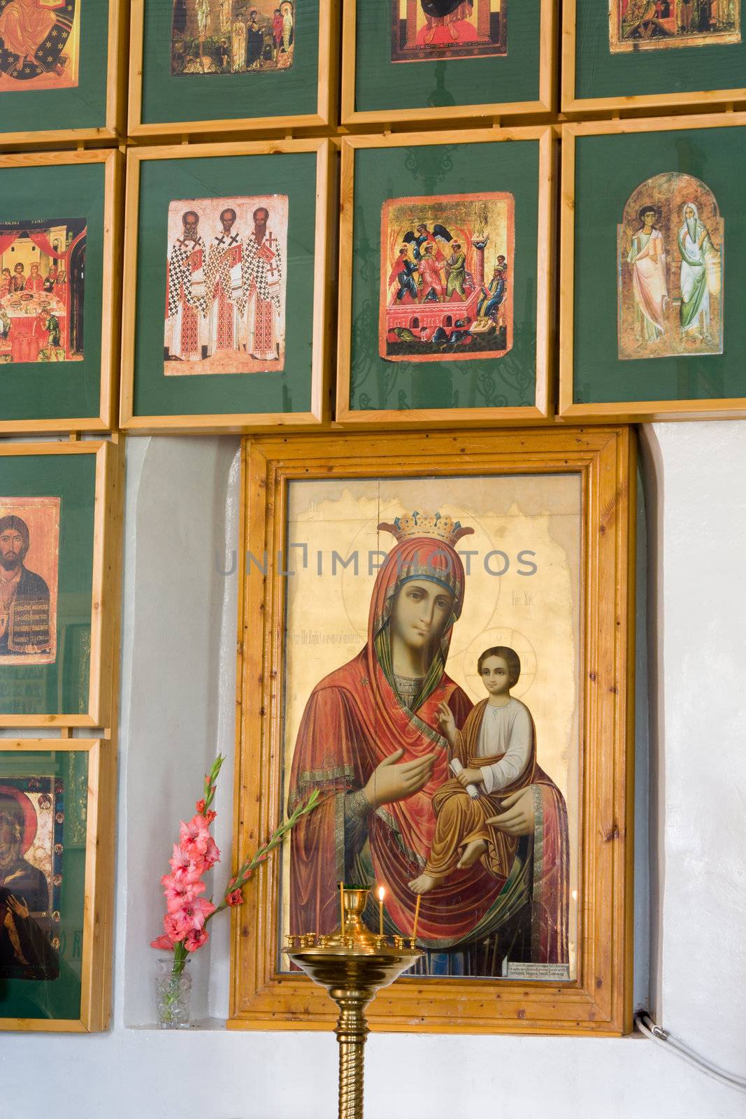 Icons in church. A burning candle.