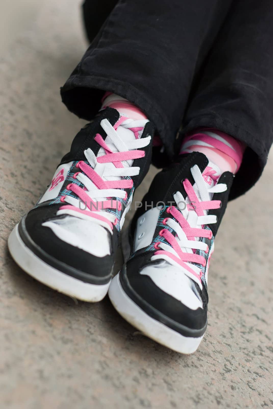 pair of Sneakers wearing on a female feet