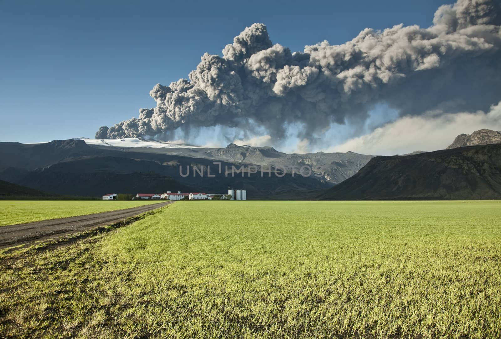 Ash cloud from the Eyjafjallajokull eruption in Iceland towering over a nearby farm