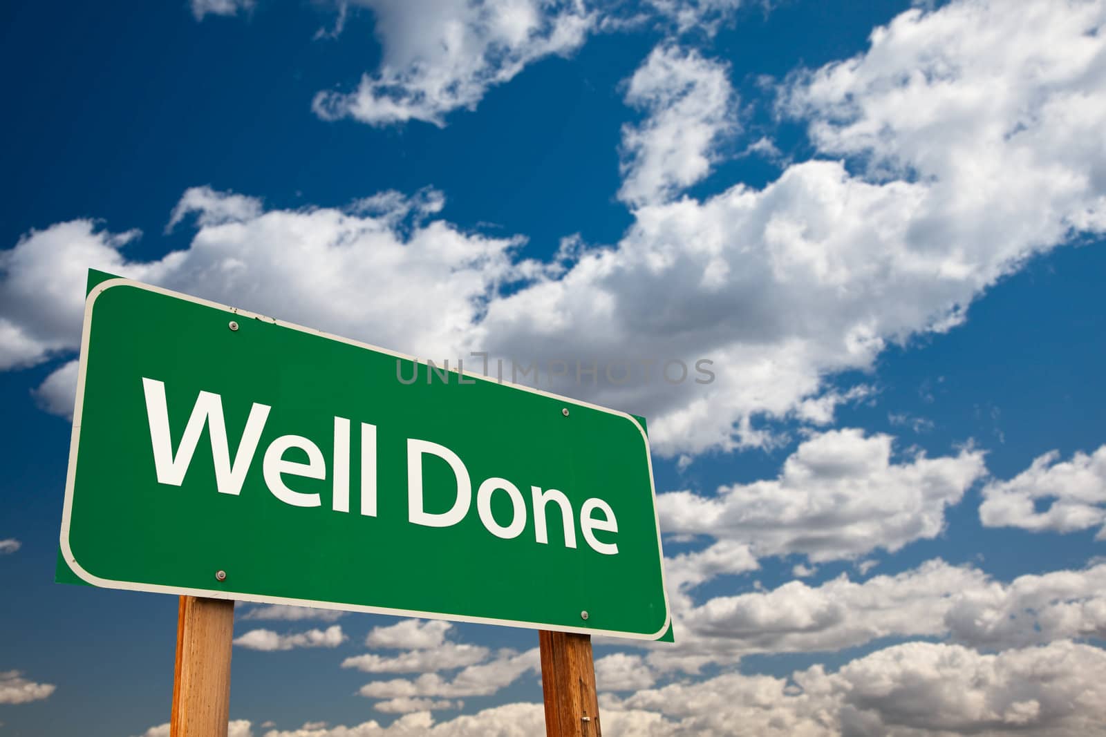 Well Done Green Road Sign with Dramatic Clouds and Sky - The Kudos Sign Series.