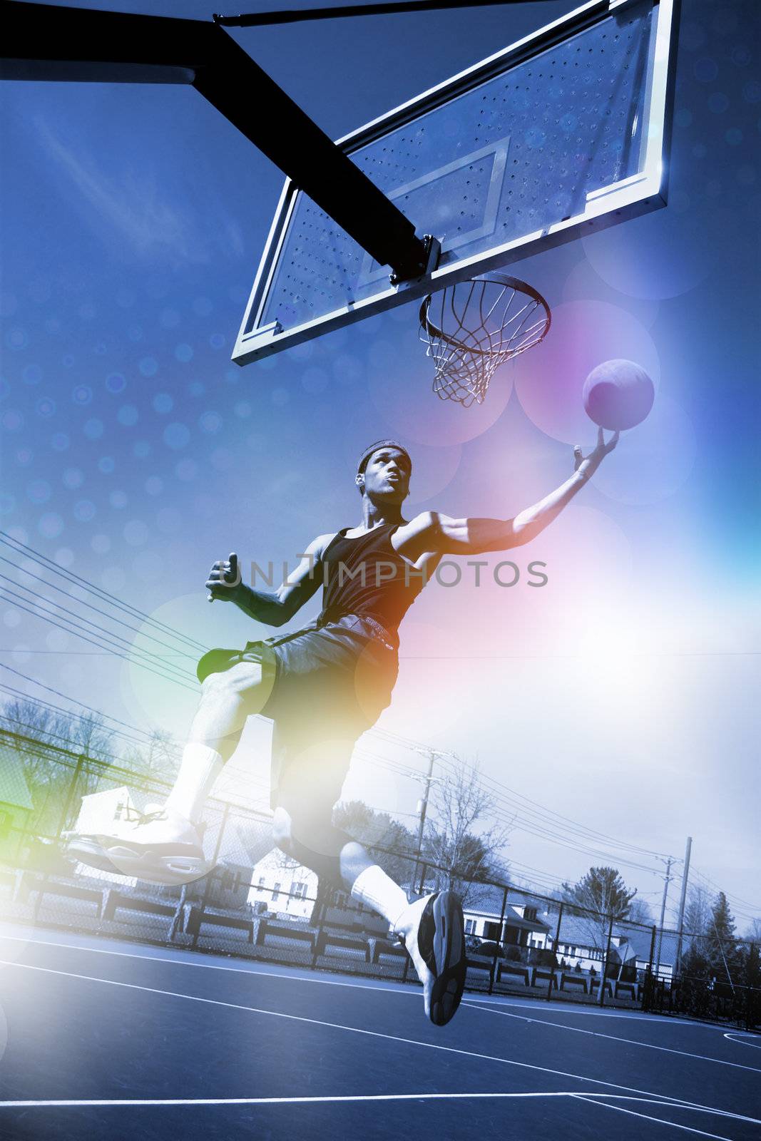 A basketball player drives to the hoop for a slam dunk with abstract rainbow lens flare and halftone effects.